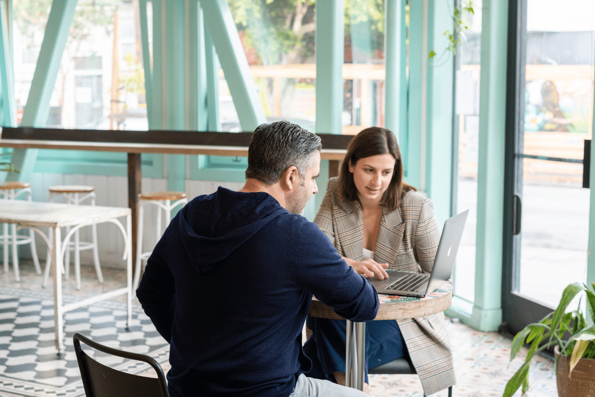 Man And Women In Discussion At Table